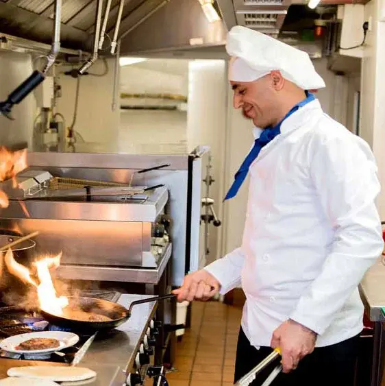Ivy Creek Chef Created Meals, chef frying a dish.