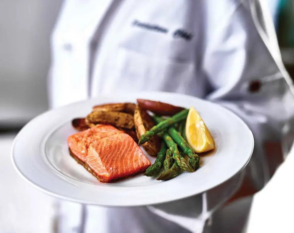 Ivy Creek Chef Created Meals, chef delivering a finished dish.